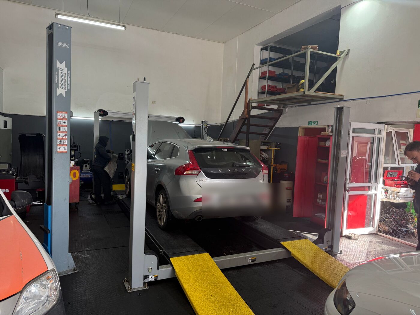 Volvo on the four-post alignment lift inside Atlantic Auto Clinic